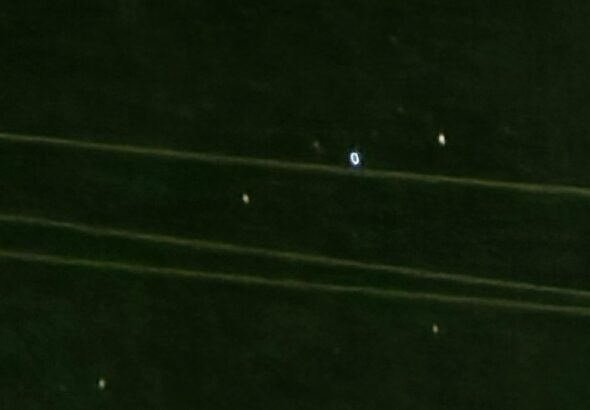 Artist concept of cold glowing orbs reacting near a military aircraft over ocean at night
