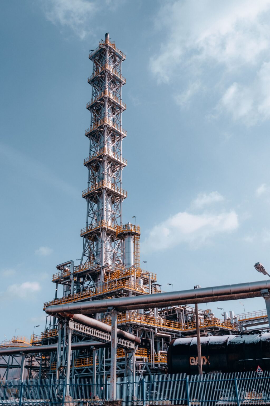 Oil refinery towers against blue sky