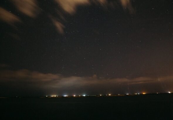 Night sky over coastline
