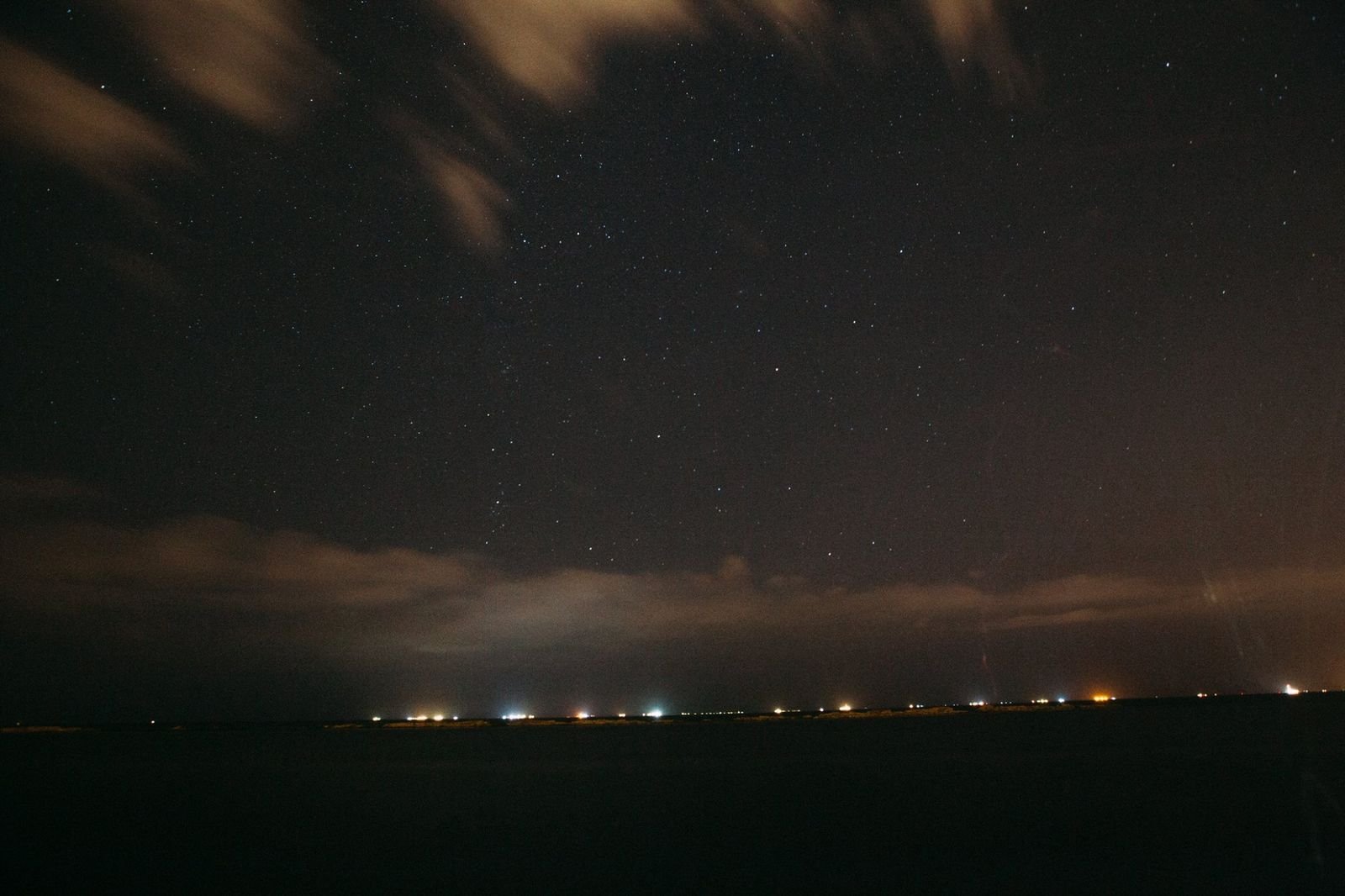 Night sky over a coastline